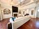 Open living room featuring a fireplace, built-in shelving and hardwood floors at 1570 Oakford Rd, Sarasota, FL 34240