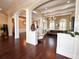 Beautiful living area featuring hardwood floors, custom columns, arched entryways, and neutral paint tones at 1570 Oakford Rd, Sarasota, FL 34240