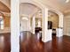 Stunning living area featuring hardwood floors, elegant columns, arched entryways, and natural light at 1570 Oakford Rd, Sarasota, FL 34240