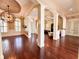 Bright and airy living area showcasing hardwood floors, architectural columns, and an ornate lighting fixture at 1570 Oakford Rd, Sarasota, FL 34240