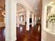 Bright living room showcasing hardwood floors, detailed columns, and arched walkways at 1570 Oakford Rd, Sarasota, FL 34240