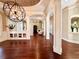 Spacious living room with detailed columns, hardwood floors, and unique lighting fixture at 1570 Oakford Rd, Sarasota, FL 34240