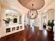 Bright living room showcasing hardwood floors, detailed columns, and unique lighting fixture at 1570 Oakford Rd, Sarasota, FL 34240