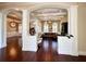 Spacious living room boasts hardwood floors, columns, arched doorways, and neutral paint tones at 1570 Oakford Rd, Sarasota, FL 34240