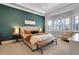Spacious main bedroom with a decorative wall, bench, and bedside tables at 1570 Oakford Rd, Sarasota, FL 34240