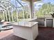 The outdoor kitchen is perfect for entertaining with a built-in grill and a bar at 1570 Oakford Rd, Sarasota, FL 34240
