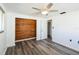 Bedroom featuring modern flooring, a cedar-lined closet, and a ceiling fan at 10105 Vineyard Ln, Port Richey, FL 34668