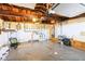 Spacious garage featuring exposed wooden beams, white storage cabinets and concrete flooring at 10105 Vineyard Ln, Port Richey, FL 34668