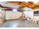 Spacious garage with overhead door, exposed rafters, and ample storage space at 10105 Vineyard Ln, Port Richey, FL 34668