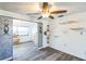 Spacious living room featuring modern flooring, stylish wall decor, and a ceiling fan at 10105 Vineyard Ln, Port Richey, FL 34668