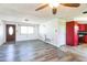 Bright living room with sleek floors and view into the red-cabineted kitchen at 10105 Vineyard Ln, Port Richey, FL 34668