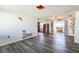 Open-concept living room featuring sleek gray wood flooring, perfect for entertaining and relaxation at 10105 Vineyard Ln, Port Richey, FL 34668
