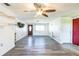 Spacious living room with new gray wood flooring, an entry door, and a bright window at 10105 Vineyard Ln, Port Richey, FL 34668