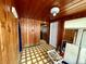 Mud room with knotty pine walls and a cream-colored, geometric floor tile at 2155 Webber St, Sarasota, FL 34239