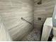 Modern shower with tiled walls, a showerhead, and a built-in grab bar at 2155 Webber St, Sarasota, FL 34239