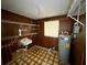 Utility room with a vintage sink, water heater, and wire shelving at 2155 Webber St, Sarasota, FL 34239
