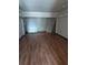Basement area with laminate flooring and neutral walls with exposed infrastructure at 2155 Wood St # B4, Sarasota, FL 34237