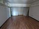 Basement area with laminate flooring and neutral walls ready for customization and storage at 2155 Wood St # B4, Sarasota, FL 34237