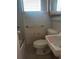 Compact bathroom with basic fixtures; requires renovation and modernization at 2155 Wood St # B4, Sarasota, FL 34237