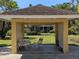 Charming cabana with seating area overlooking a manicured lawn and lush landscaping at 2155 Wood St # B4, Sarasota, FL 34237
