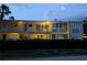 A cozy two-story condominium complex with classic exterior, featuring mature landscaping at 2155 Wood St # B4, Sarasota, FL 34237