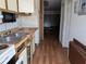 Outdated kitchen featuring laminate countertops and a stainless steel double sink at 2155 Wood St # B4, Sarasota, FL 34237