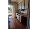 View of kitchen with appliances and cabinets, plus access to exterior balcony at 2155 Wood St # B4, Sarasota, FL 34237