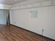Empty living room featuring wooden floors, shelving and an open doorway at 2155 Wood St # B4, Sarasota, FL 34237