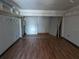 Large living room with hardwood floors and ample storage at 2155 Wood St # B4, Sarasota, FL 34237
