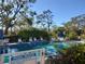 Relaxing community pool surrounded by mature trees and plenty of seating, perfect for summer days at 2155 Wood St # B4, Sarasota, FL 34237