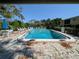 Community pool with lounge chairs, lush landscaping, and clear blue water for relaxation at 2155 Wood St # B4, Sarasota, FL 34237