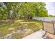 Spacious backyard with a patio and furniture, featuring mature trees providing shade and a level grassy area at 13004 Waterbourne Dr, Gibsonton, FL 33534