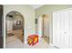 Hallway with an archway and a red and yellow miniature table and chairs at 13004 Waterbourne Dr, Gibsonton, FL 33534