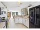 Well-appointed kitchen with white cabinets, stainless steel appliances, and open layout to the dining area at 13004 Waterbourne Dr, Gibsonton, FL 33534