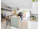 Open-concept kitchen with island seating and sleek white cabinetry at 13004 Waterbourne Dr, Gibsonton, FL 33534
