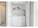 Convenient laundry room with a washer, dryer, and shelving for storage at 13004 Waterbourne Dr, Gibsonton, FL 33534