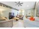 Comfortable living room with stylish decor, neutral paint, plenty of seating, and lots of natural light at 13004 Waterbourne Dr, Gibsonton, FL 33534