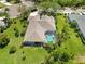 A beautiful aerial view of a single Gathering home with a screened in pool, a well manicured lawn, and lush landscaping at 13136 Peregrin Cir, Bradenton, FL 34212