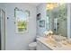 Bright bathroom with a large vanity, neutral color scheme, framed mirror, and a walk-in shower with glass door at 13136 Peregrin Cir, Bradenton, FL 34212