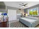 Cozy bedroom features a calm grey palette with lots of natural light and vinyl plank flooring at 13136 Peregrin Cir, Bradenton, FL 34212