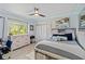 Bright bedroom with modern decor, a ceiling fan, large window, and sleek furniture at 13136 Peregrin Cir, Bradenton, FL 34212