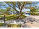 Charming blue single-story home with a well manicured front lawn and mature trees at 13136 Peregrin Cir, Bradenton, FL 34212