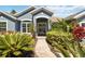 Beautiful front entrance with double doors, sidelights and elegant landscaping at 13136 Peregrin Cir, Bradenton, FL 34212