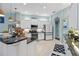 Updated kitchen featuring white cabinets, stainless steel appliances, granite countertops, and tile backsplash at 13136 Peregrin Cir, Bradenton, FL 34212