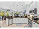 Well-lit kitchen with stainless steel appliances, granite countertops, white cabinets, and a view to the dining area at 13136 Peregrin Cir, Bradenton, FL 34212