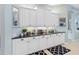 Close up of countertops and white cabinetry in an eat in kitchen with tile flooring and stainless steel appliances at 13136 Peregrin Cir, Bradenton, FL 34212