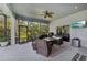 Spacious screened lanai featuring an outdoor dining area, lounge seating, and a mounted television at 13136 Peregrin Cir, Bradenton, FL 34212