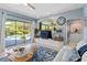 Bright living room featuring an entertainment center and sliding doors to the outdoor pool at 13136 Peregrin Cir, Bradenton, FL 34212