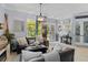 Comfortable living room with dark leather furniture, lots of natural light, and tasteful decor at 13136 Peregrin Cir, Bradenton, FL 34212