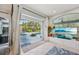 Bright living room with large sliding glass doors opening to a screened-in pool and patio area at 13136 Peregrin Cir, Bradenton, FL 34212